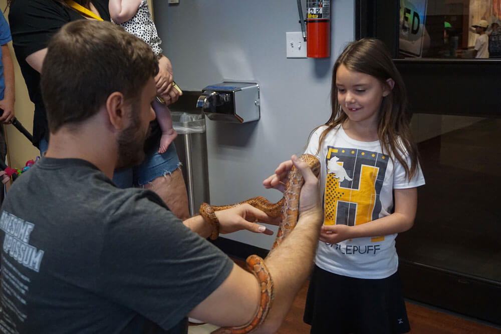 children holding a snake