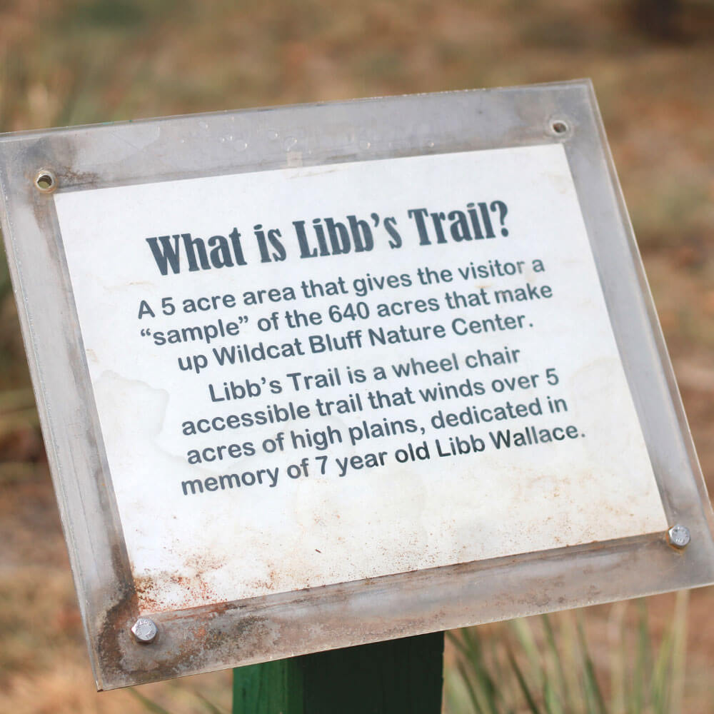 a sign on a trail