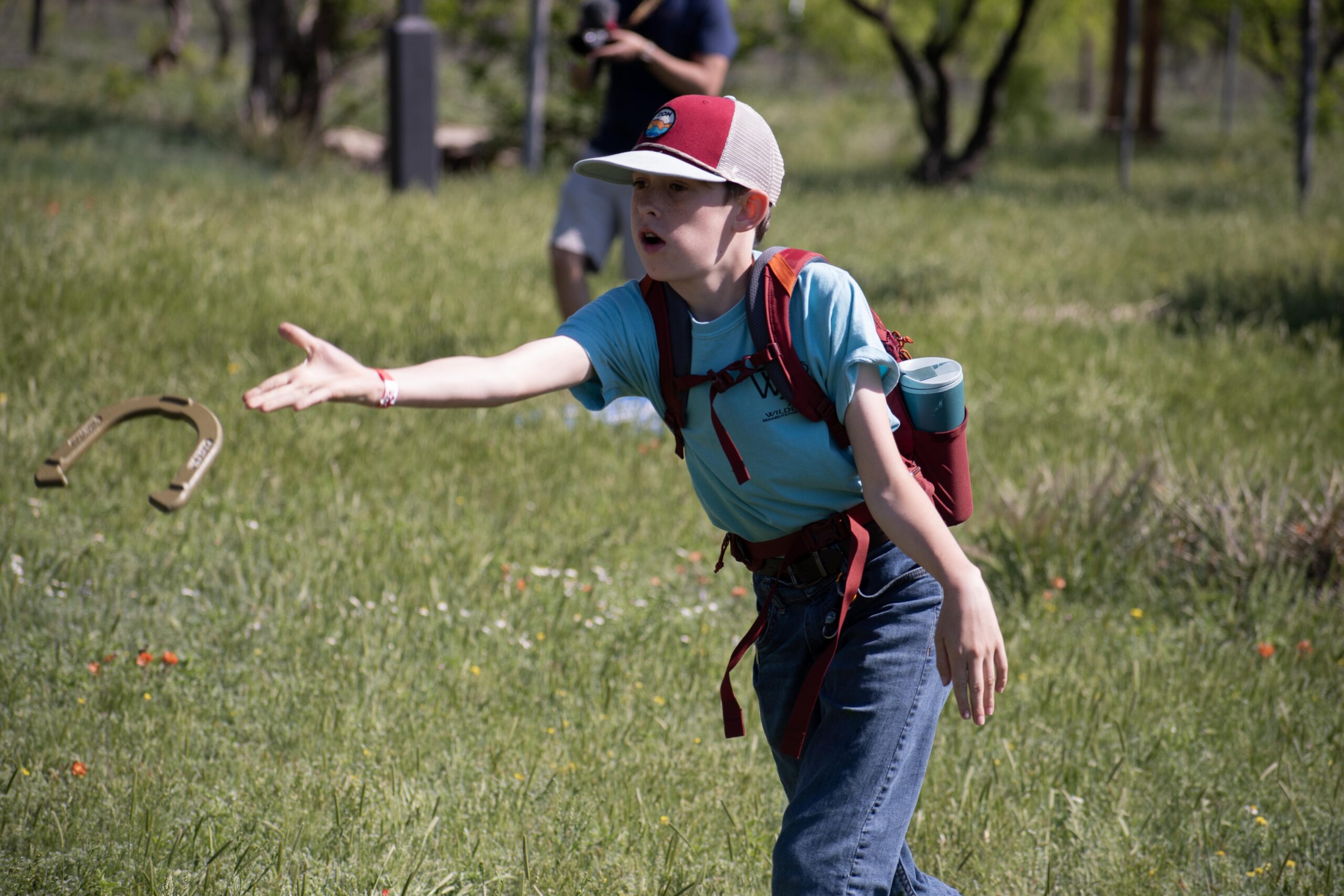 YOung camper throwing horseshoes Outdoor science and nature camp at Wildcat Bluff